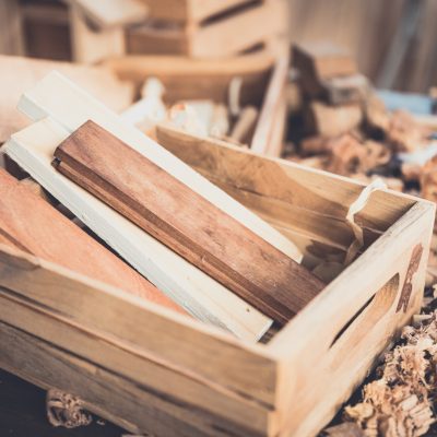Background image of woodworking workshop, carpenters work table with different tools and wood cutting stand, vintage filter image