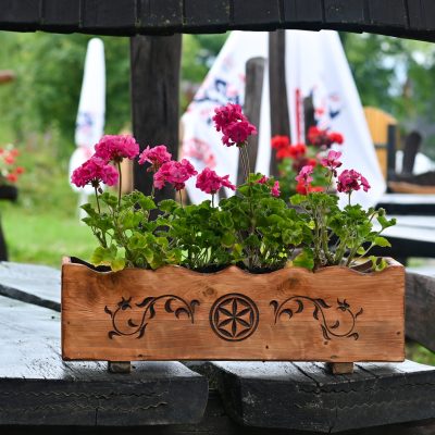 Beautiful wooden pot with geranium flowers